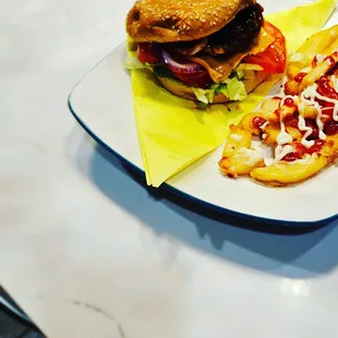 a plate with a sandwich and a slice of pizza