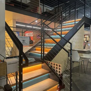 Colorful stairs to upstairs seating area.