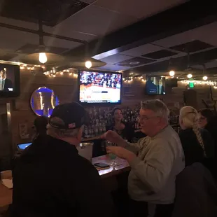 a group of people sitting at a bar