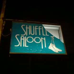 a sign for shuffle's saloon