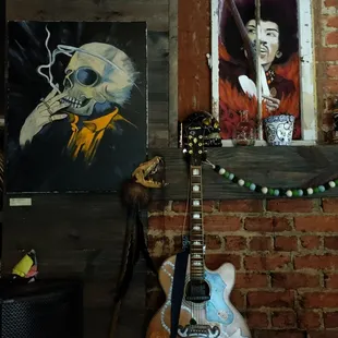 a man smoking a cigarette and a guitar