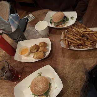 Spread of burgers, fries, and buffalo chicken egg roll