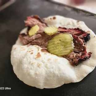 a pulled pork sandwich with pickles