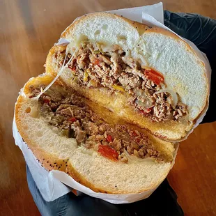 a person holding a sandwich