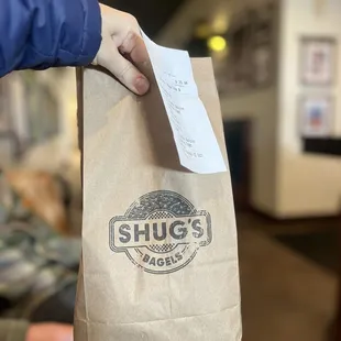 a person holding a paper bag