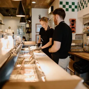 a man and a woman preparing food