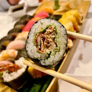 a sushi with chopsticks in front of it