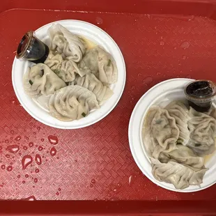 two bowls of noodles and a bottle of beer