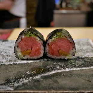 two pieces of sushi on a plate