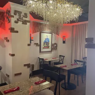 a dining room with a chandelier hanging from the ceiling