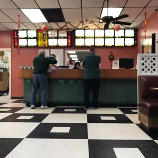 two men standing at the counter