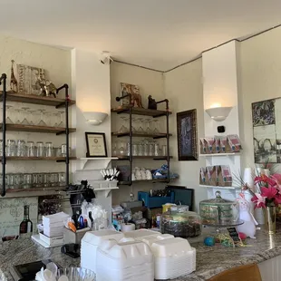 a kitchen with a counter and shelves