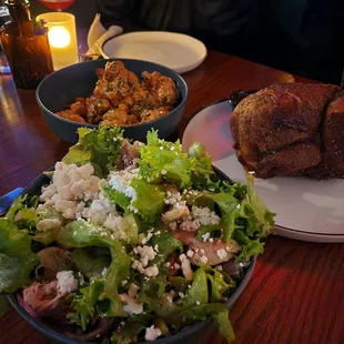 a plate of salad and a plate of chicken