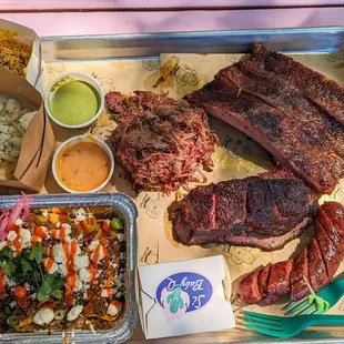 Pork Spare Ribs, Brisket, Pulled Lamb Shoulder, Sausage Link, Smoked Kimchi, Dan Dan Frito Pie, Queso y Pepe, and Sahil's Aloo