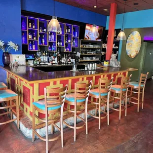 a bar with chairs