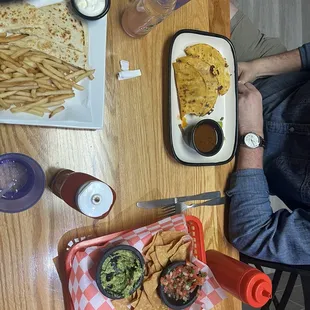 Full meal: rice and beans, chips and guacamole and salsa, kids, quesadilla, and fries