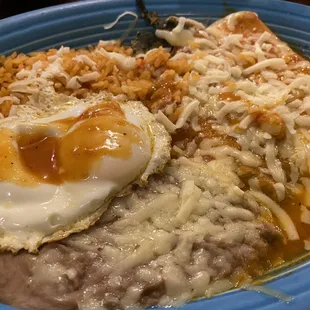 My 2 item combo. A cheese enchilada and a Chili  Relleno with a fried egg on top.