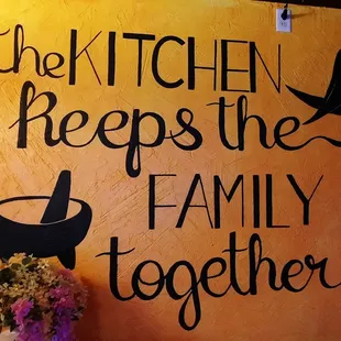 a sign that says, the kitchen keeps the family together