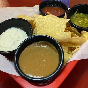 Chips and 2 kinds of salsa, warm bean dip, crema