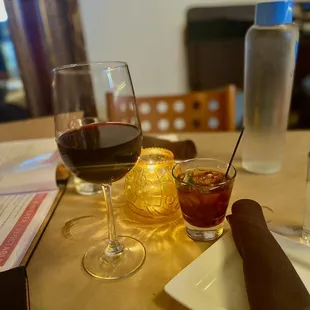 two glasses of wine and a napkin on a table