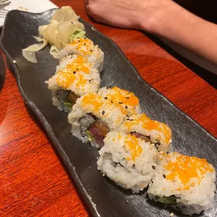 sushi rolls on a black plate