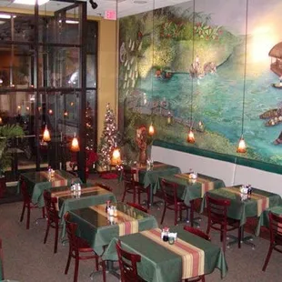a dining area with tables and chairs