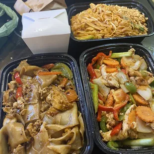 three trays of asian food