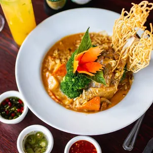 Lamb shanks in massamun curry paired with broccolli, carrot, onion, and potatoe