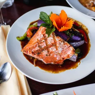 Grilled Salmon With fresh basil and garlic sauce paired with crispy eggplant.