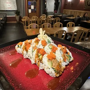 a sushi roll on a red plate