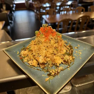 a square plate of noodles and vegetables