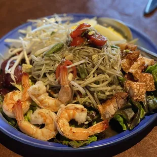 a plate of shrimp and noodles
