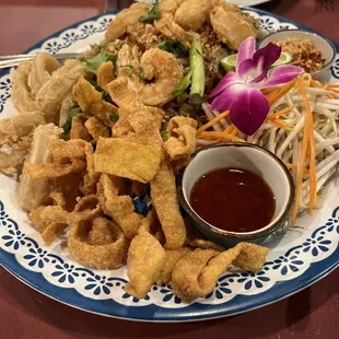 a plate of fried food with dipping sauce