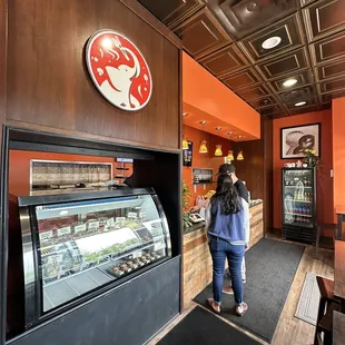 a woman standing in front of the counter