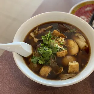 a bowl of soup and a plate of rice
