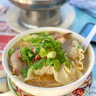 a bowl of soup with noodles and meat
