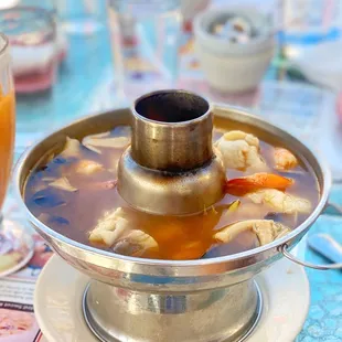 a bowl of soup and a glass of orange juice