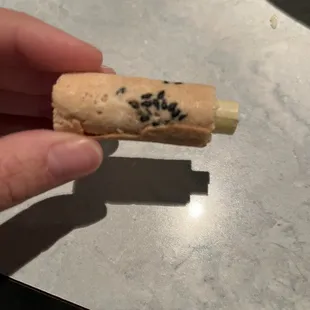 Rolled fortune cookie with sesame seeds