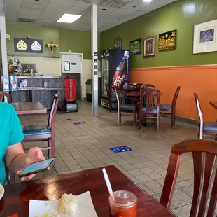 a woman sitting at a table in a restaurant