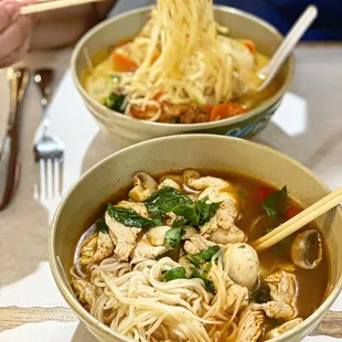 two bowls of noodle soup with chopsticks