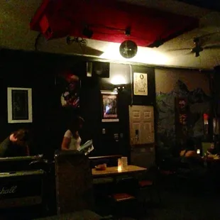 people sitting at tables in a dimly lit room