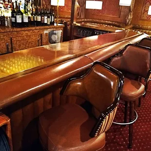 a row of leather bar stools