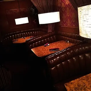 a corner booth with a table and chairs