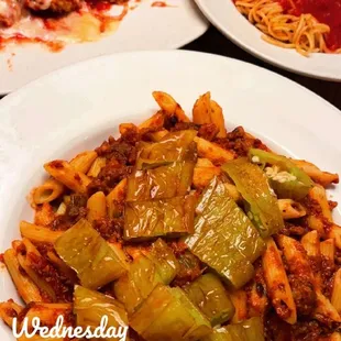 Veal Parmesan in the background with side of spaghetti and the Penne Arabiatta with peppers added!