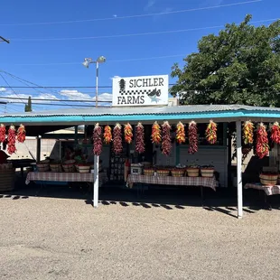 a food stand with chili hanging from the roof