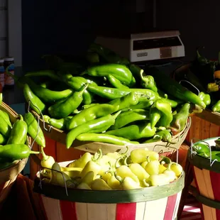a variety of peppers in baskets