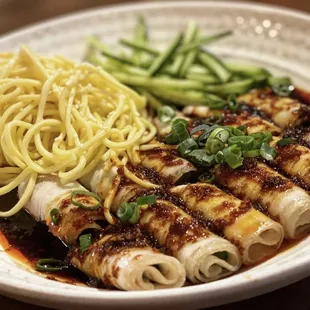 a plate of food with noodles and meat