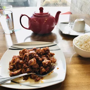 a plate of food and a teapot