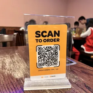 a scan to order sign on a table