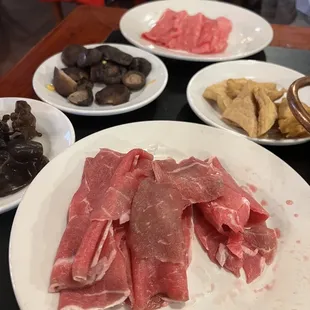 Q selection of vegetables and meat to put in the hot pot.
